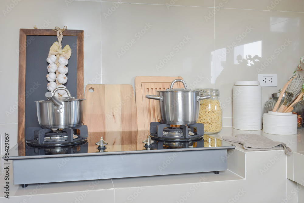 stainless pan on gas stove with utensil in modern kitchen stainless pan on gas stove with utensil in modern kitchen