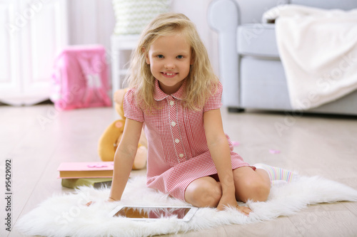 Little girl with tablet in ...
