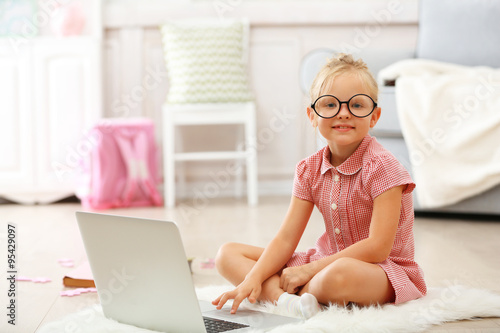 Little girl with laptop in ...