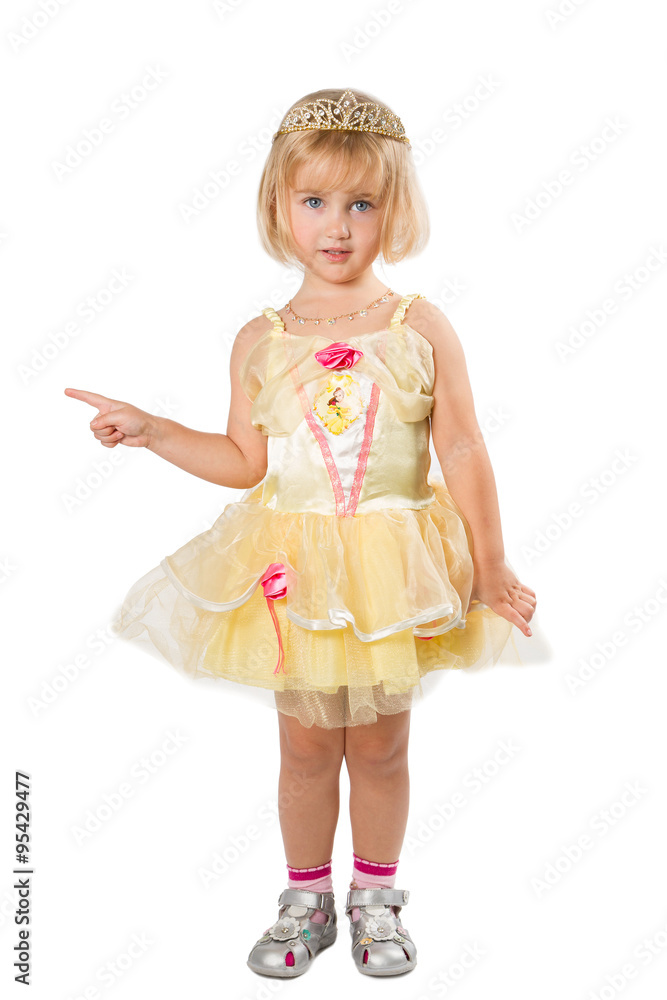 Little girl in a beautiful yellow dress pointing his finger on Little girl in a beautiful yellow dress pointing his finger on