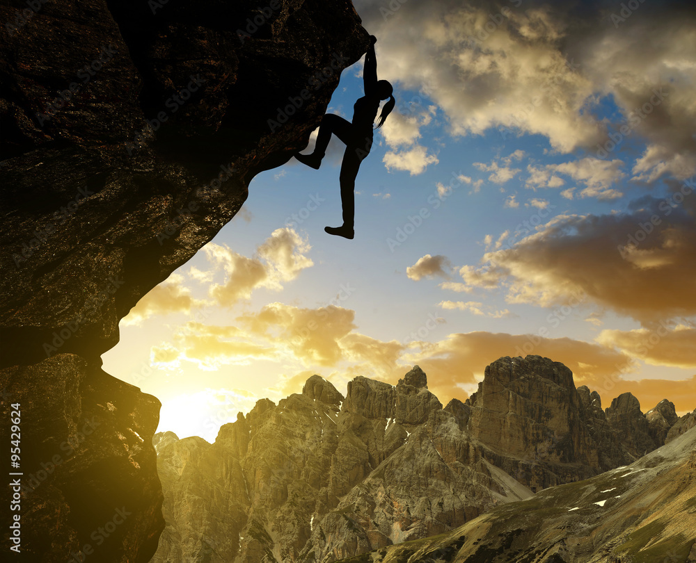 Silhoutte of girl climbing on rock at sunset in Sexten Dolomites, South Tyrol, Italy Silhoutte of girl climbing on rock at sunset in Sexten Dolomites, South Tyrol, Italy