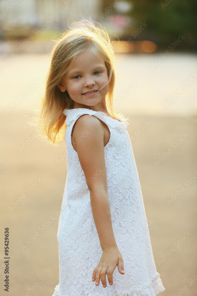 Outdoor portrait of cute little girl in city. Outdoor portrait of cute little girl in city.
