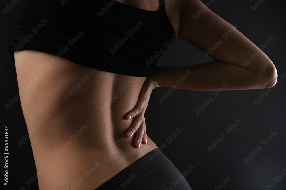 Naklejka premium Slim female body in nice black lingerie on dark background