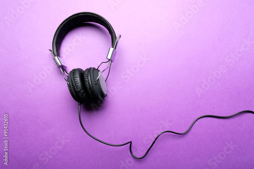 Black headphones on purple background