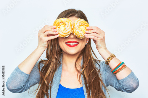 Portrait of smiling woman with two cakes in their eyes.