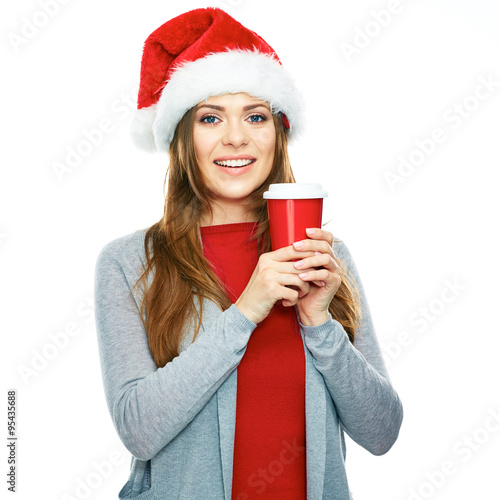 Christmas style portrait of smiling woman holding red coffee cu