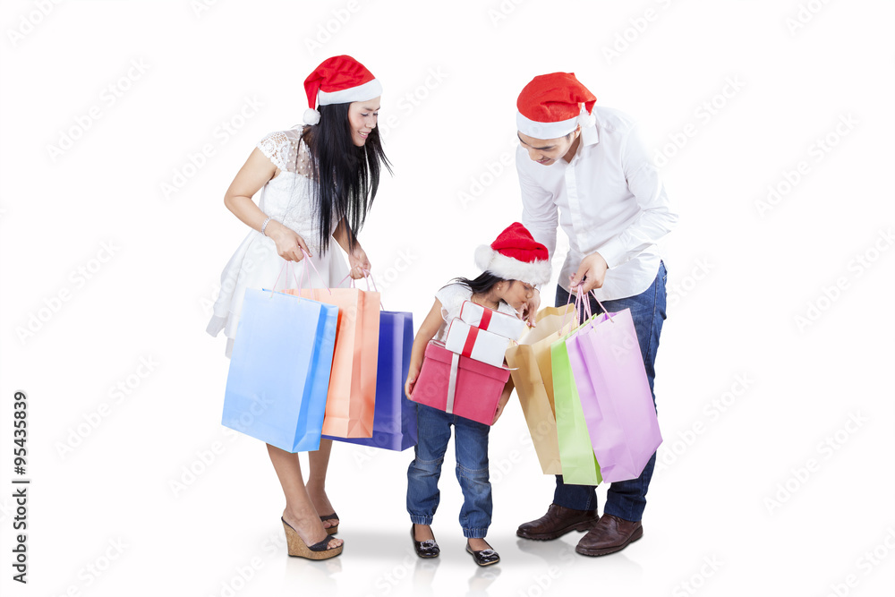Child with parents looking at shopping bags Child with parents looking at shopping bags
