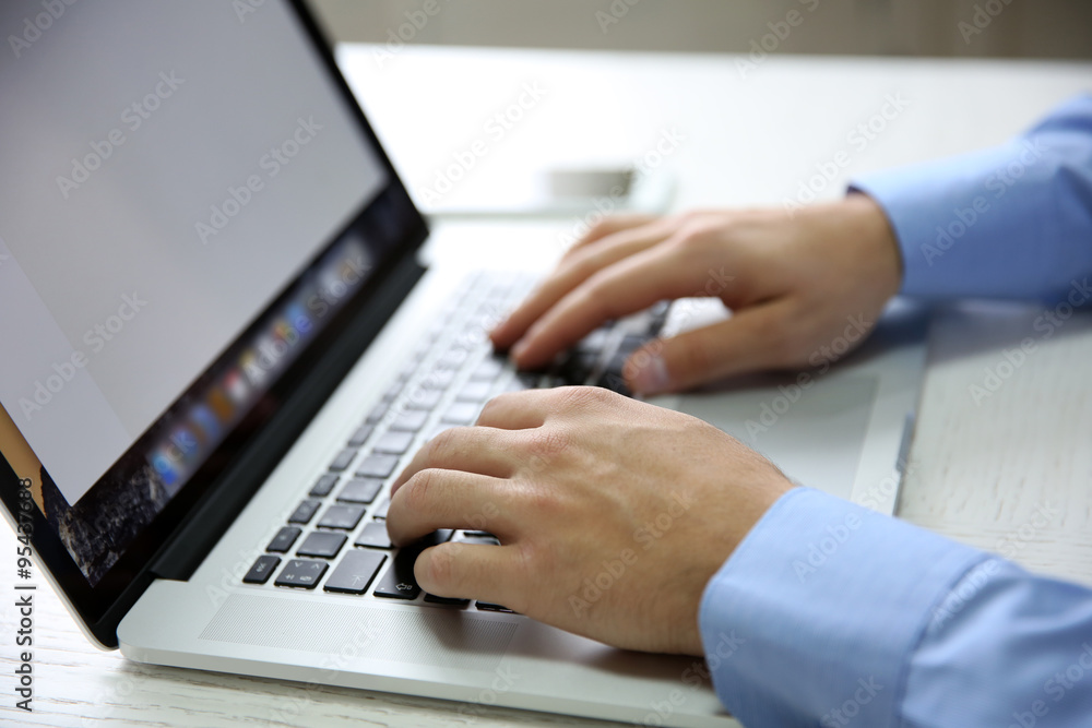 Young businessman using his laptop, close up Young businessman using his laptop, close up
