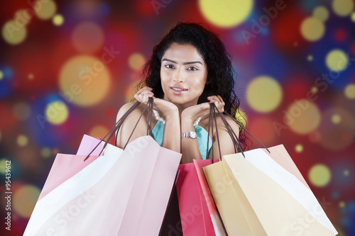 Woman with shopping bags and bokeh background