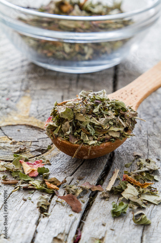 Dry herb tea in wood spoon