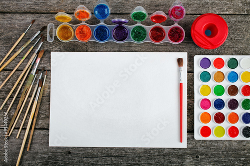 Watercolor paints set with brushes and paper sheet