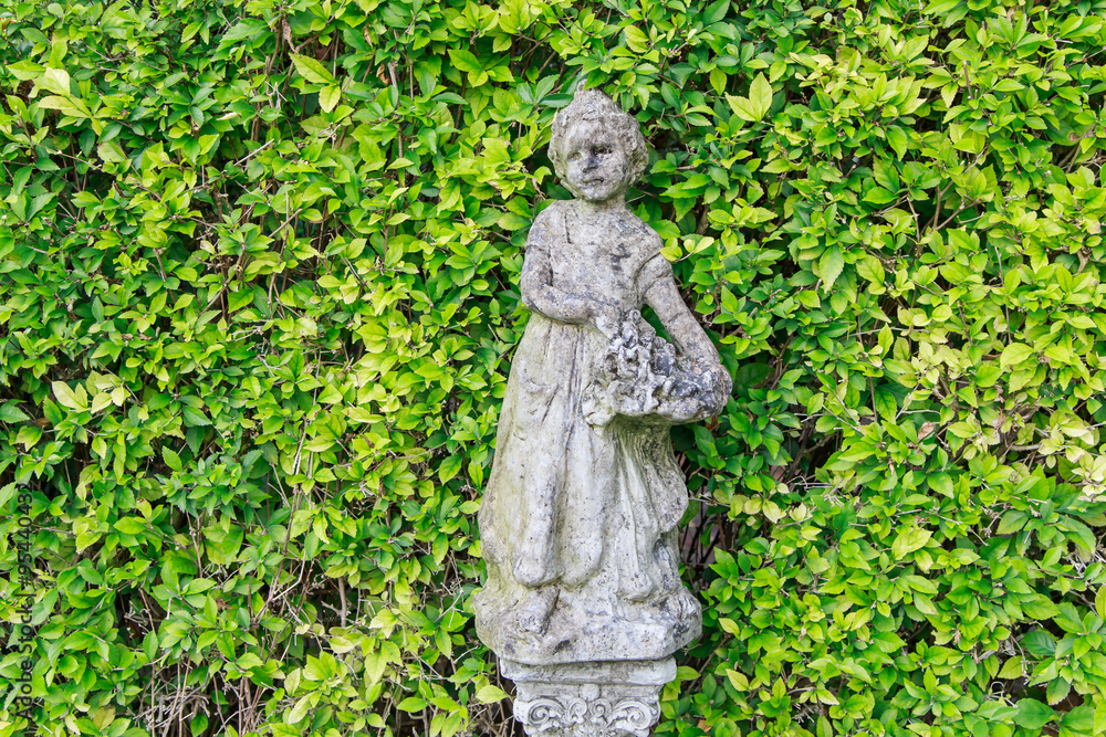 close up cement child doll in park