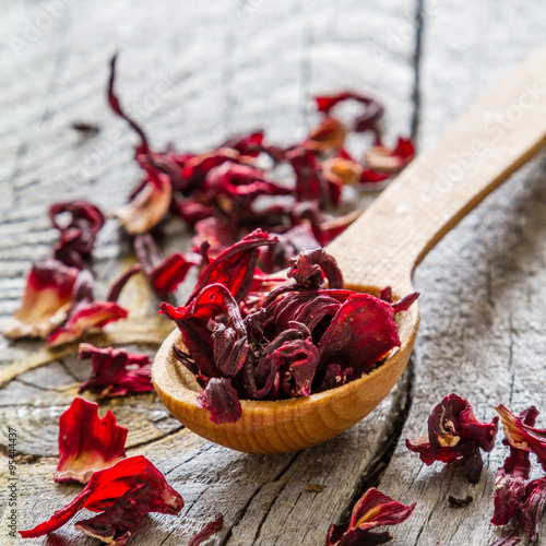 Dry hibiscus tea in wood spoon