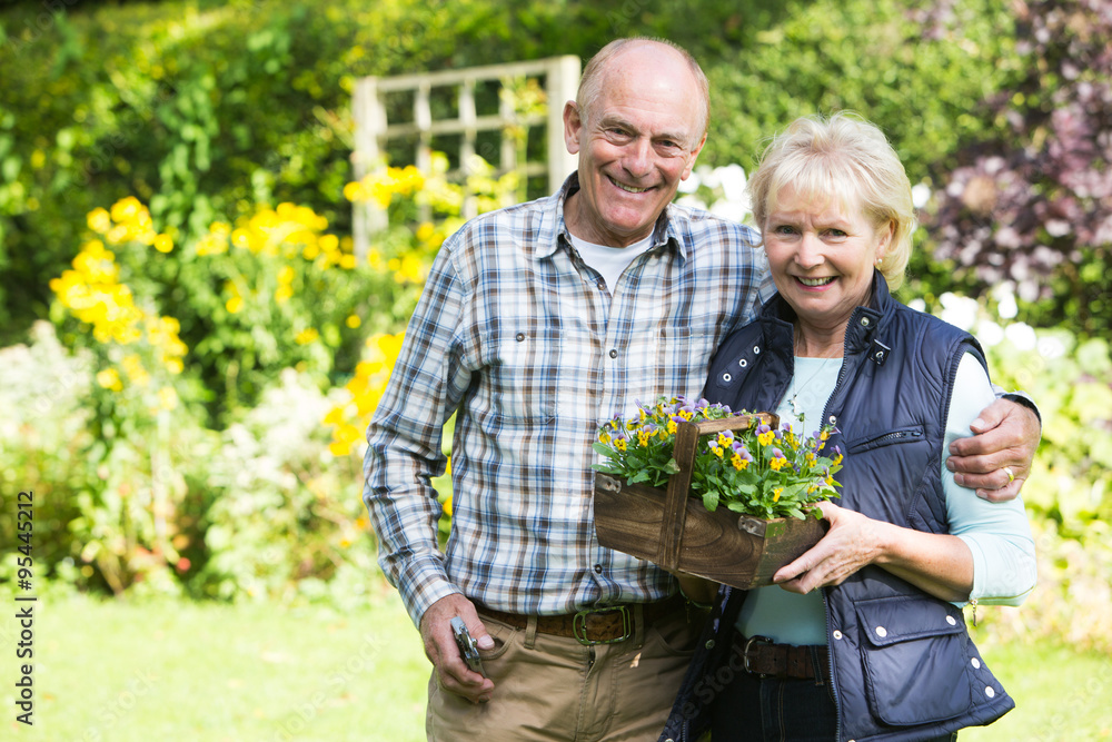 Portrait Of Senior Couple Working In Garden Together Portrait Of Senior Couple Working In Garden Together