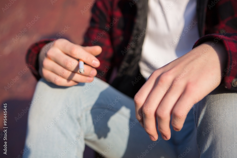 Obraz premium Close Up Of Teenage Boy Smoking Cigarette Outdoors