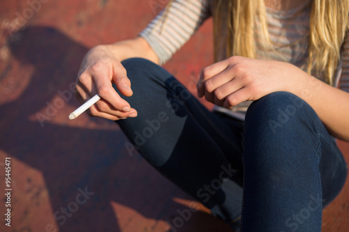 Close Up Of Teenage Girl Smoking Cigarette Outdoors © Daisy Daisy
