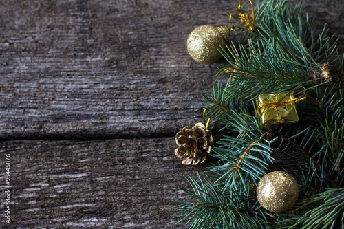 Christmas composition. Fir branches and Christmas decorations on a background of wooden boards