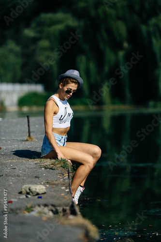 Fototapeta Naklejka Na Ścianę i Meble -  beautiful girl sitting on the pier