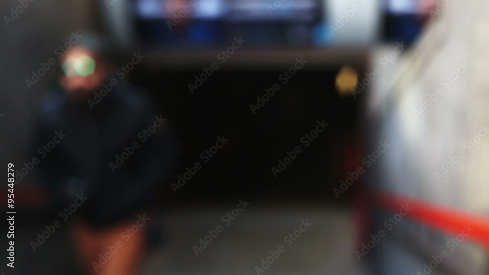 a man with anonymous face going out from the subway in a defocused background