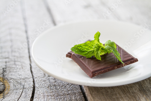 Mint leaf and chocolate, rustic wood background