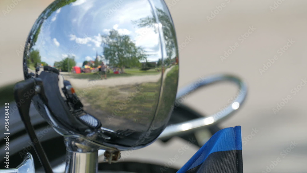 A black big motorbike on parking. Showing the side mirror of the shiny motor bike A black big motorbike on parking. Showing the side mirror of the shiny motor bike