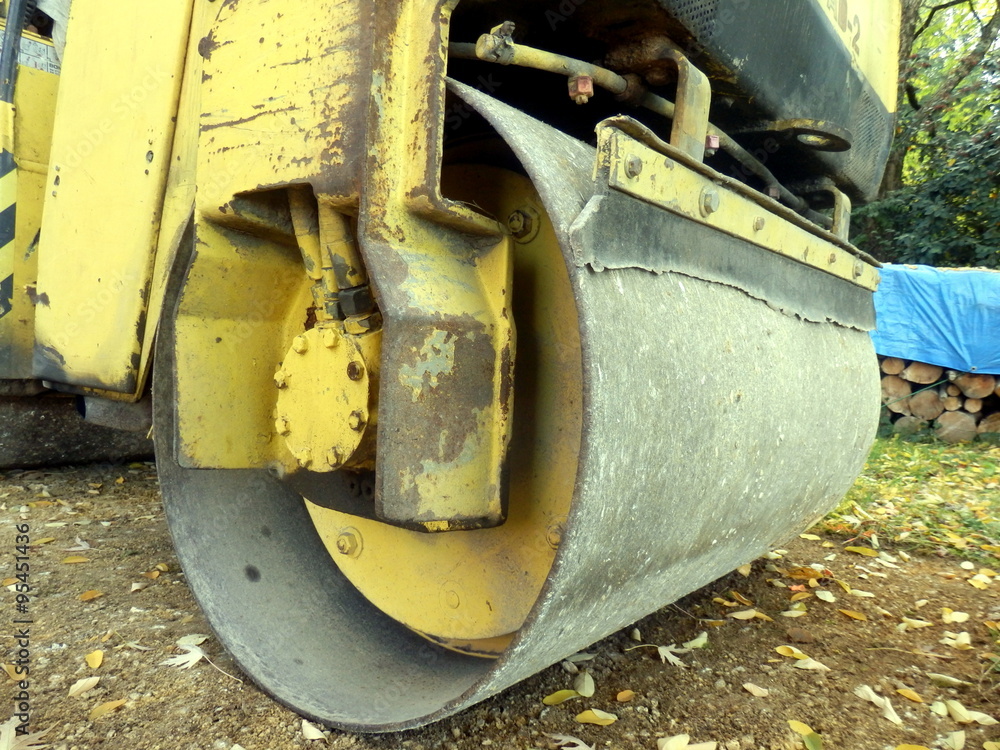 Close up of a road compactor compacting a sand and gravel drive in the countryside