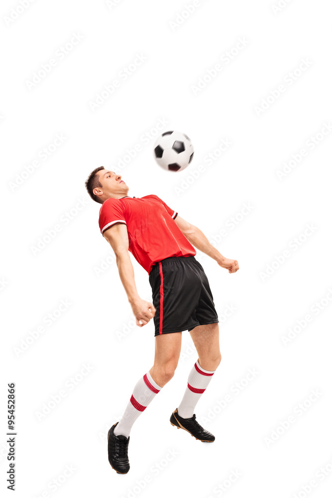 Young sportsman in red jersey playing football Young sportsman in red jersey playing football