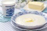 Semolina porridge with fresh butter and mug of milk