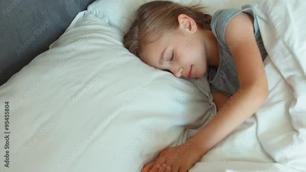 Closeup portrait girl 6-8 years old sleeping in a bed. Top view. Zooming Closeup portrait girl 6-8 years old sleeping in a bed. Top view. Zooming