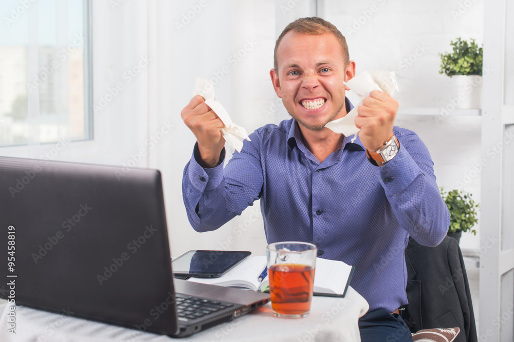 Young businessman working in the office, very concerned, a panic, crumpled paper. Young businessman working in the office, very concerned, a panic, crumpled paper.