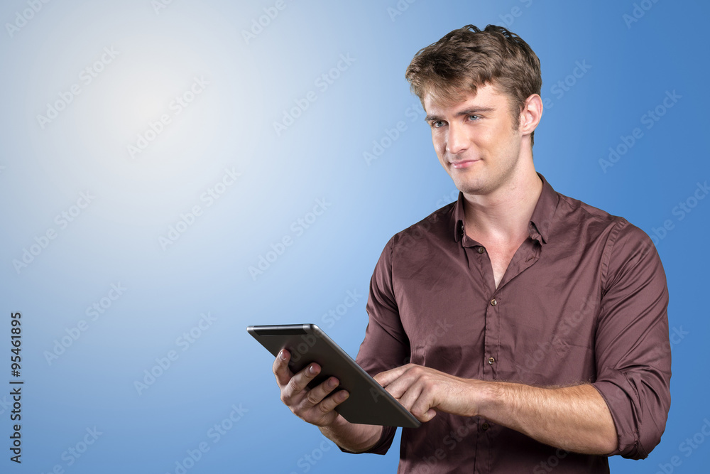 Smiling young man using tablet computer Smiling young man using tablet computer