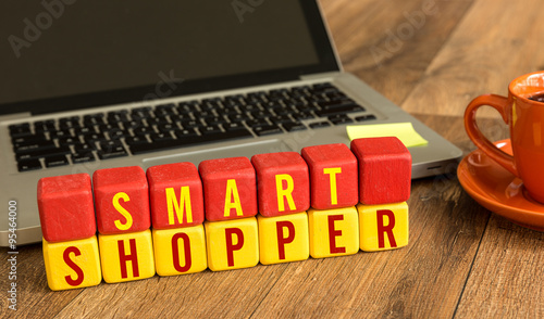 Smart Shopper written on a wooden cube in a office desk