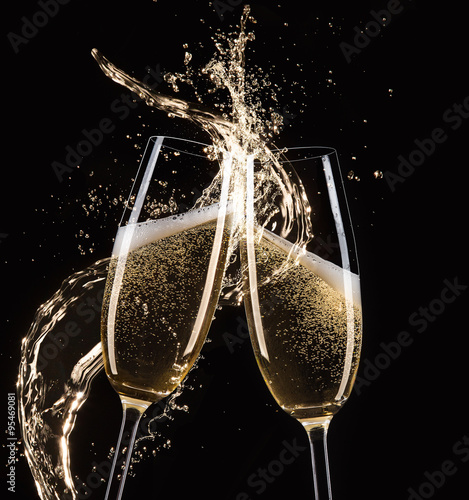 Glasses of champagne with splash, celebration theme.