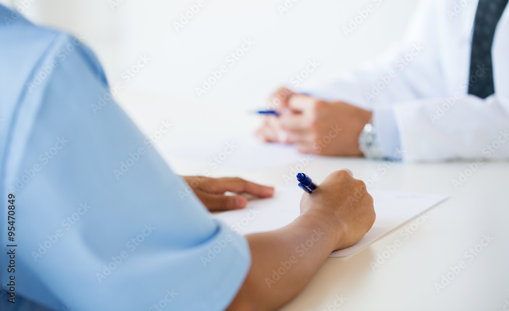 close up of doctor taking notes at hospital close up of doctor taking notes at hospital