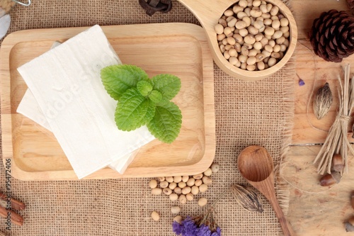 Fototapeta Naklejka Na Ścianę i Meble -  Tofu and soybeans on wood background.