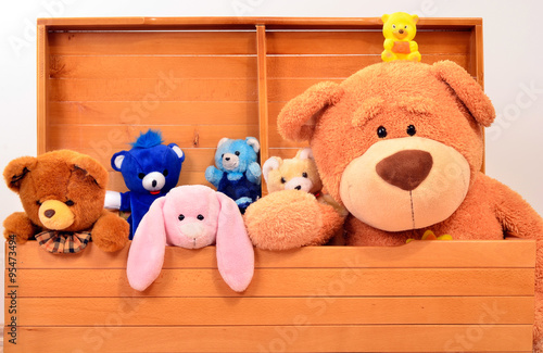Child trunk with a big teddy bear and small plush toys. Chest with cute baby toys.