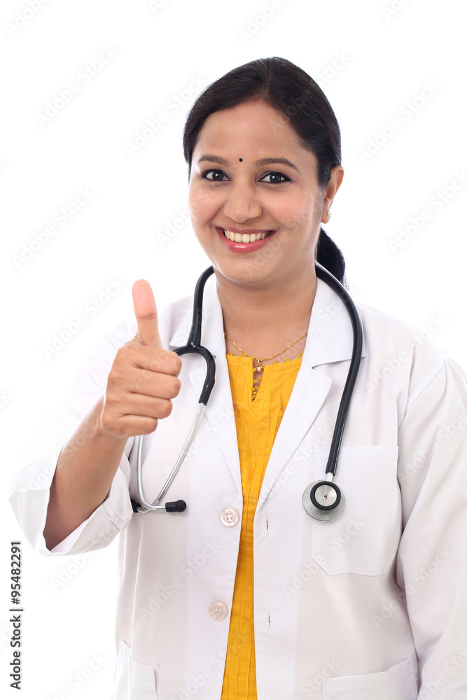 Young Indian Female Doctor showing thumbs up on white background Young Indian Female Doctor showing thumbs up on white background
