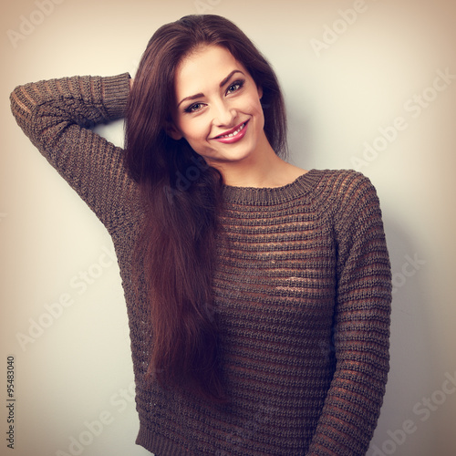 Happy young positive emotion brunette woman smiling in warm swea photo