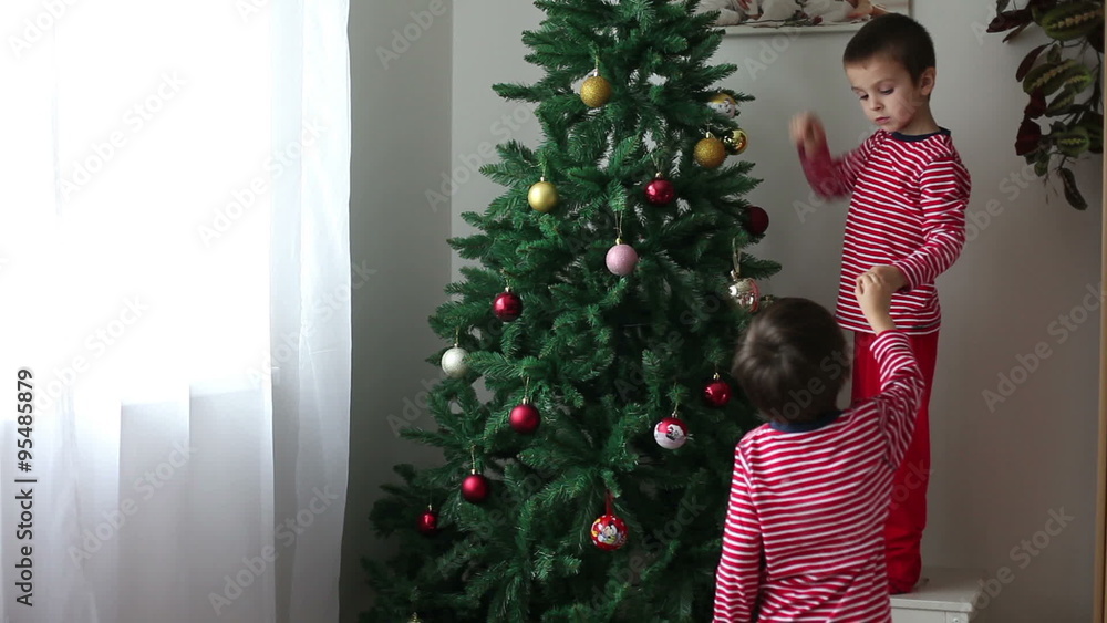Two boys, brothers, children, decorating Christmas tree Two boys, brothers, children, decorating Christmas tree