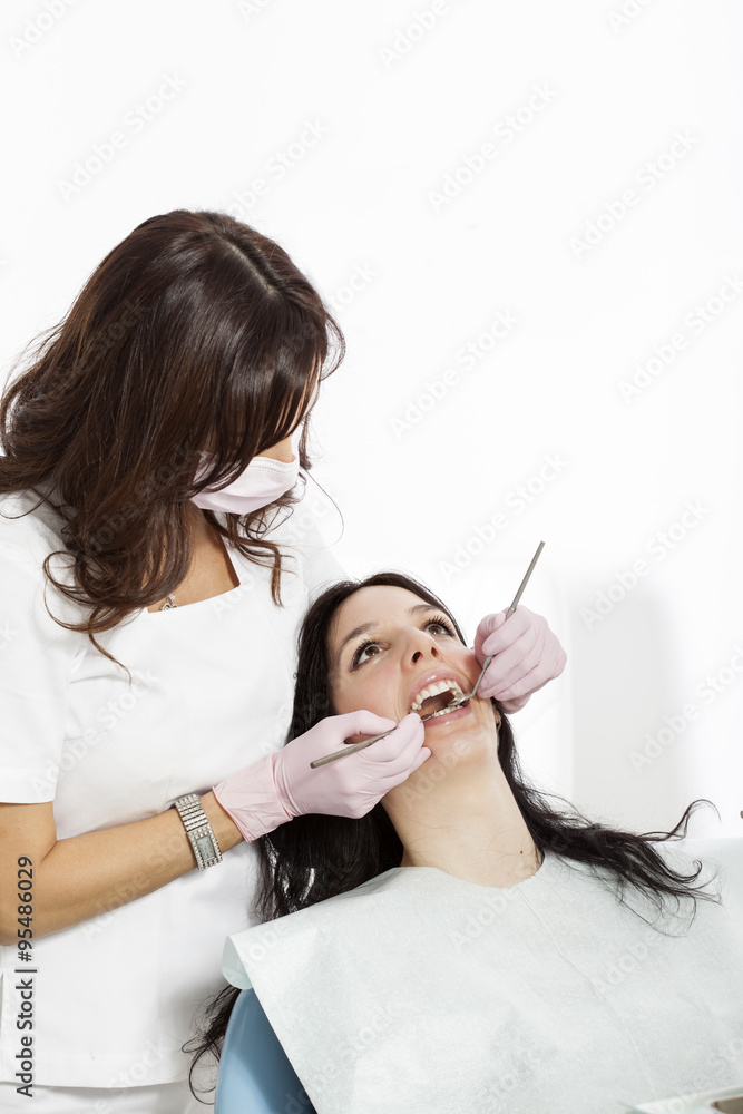 Dentist examining a patient's teeth in the dentist.copy space Dentist examining a patient's teeth in the dentist.copy space