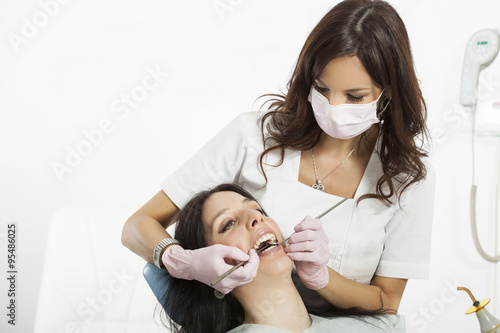 Dentist examining a patient s teeth in the dentist.copy space