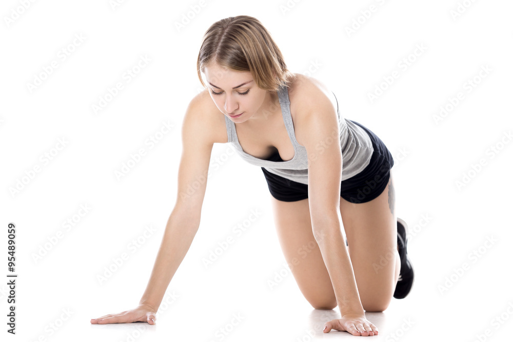Sporty woman doing preparation for push-ups Sporty woman doing preparation for push-ups