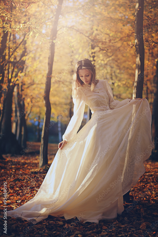 Woman with victorian dress in autumn woods