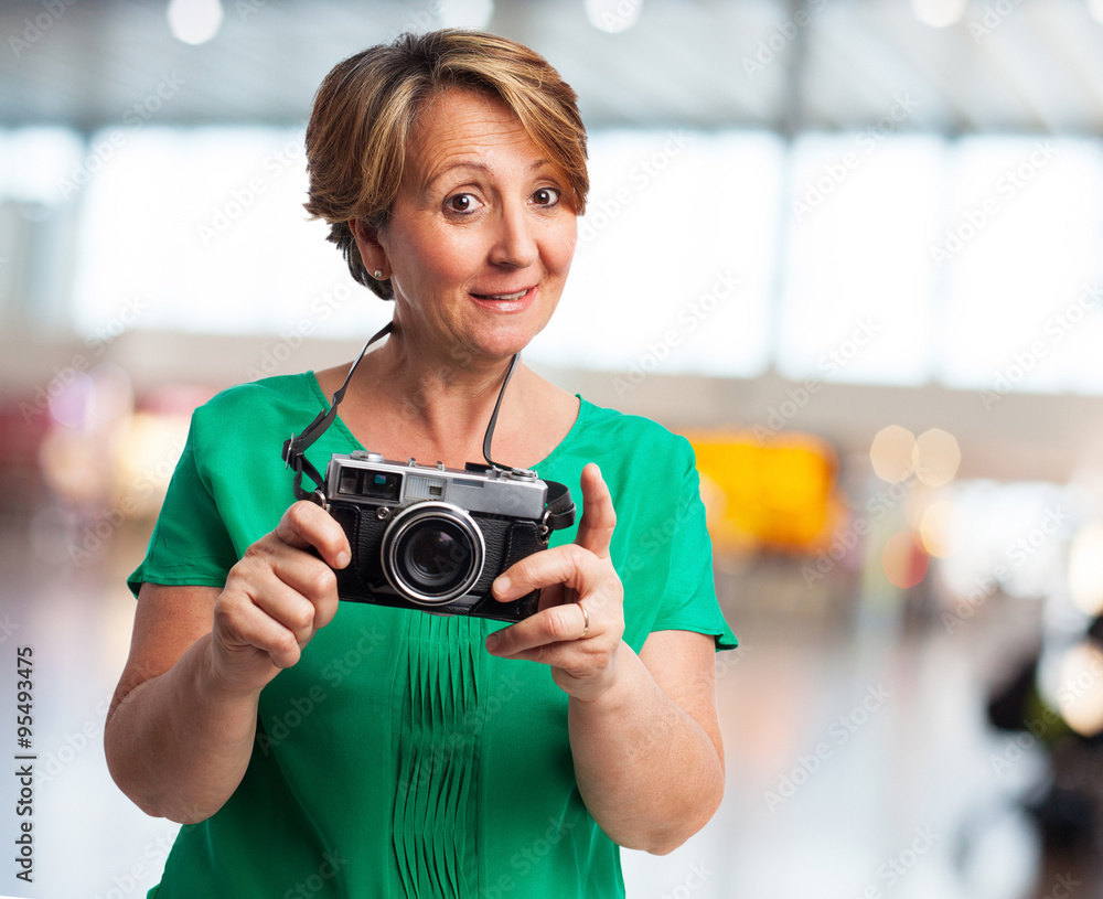 portrait of a mature woman ready to take a photo portrait of a mature woman ready to take a photo