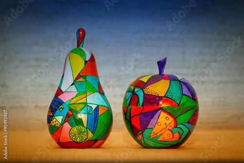 a work of art - pears and apples painted by hand paints in bright blue and orange background