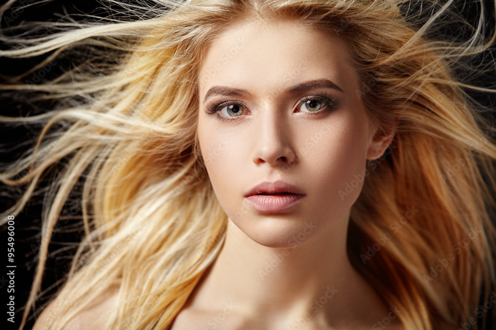 Portrait of beautiful  blonde woman with flying hair. - obrazy, fototapety, plakaty 