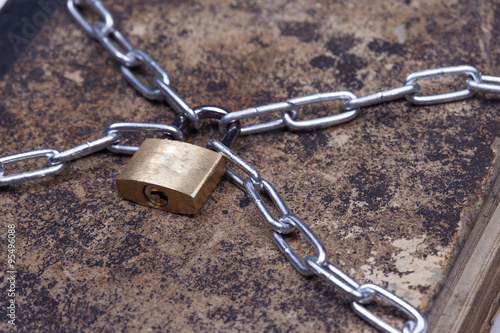 Old vintage tattered book lock with chain isolated white background