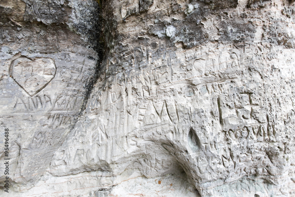 Fototapeta premium sandstone cliff wall with inscriptions