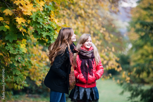 Smiling girls in the autumn park