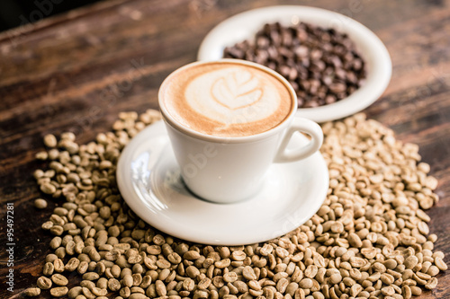 Still life of cappuccino cup and coffee beans